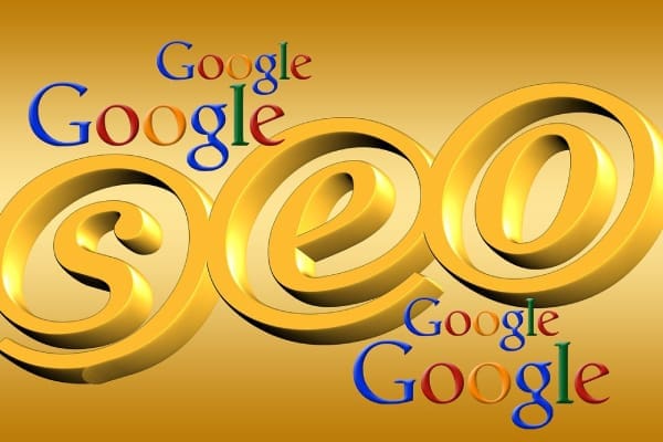Gold image of SEO looking like @ and various Google logos on gold background