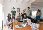 your people in casual business attire and office looking at computer and website