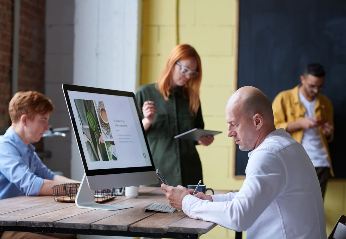 Web designer using AI tools to create a strategic website design with human creativity and expertise