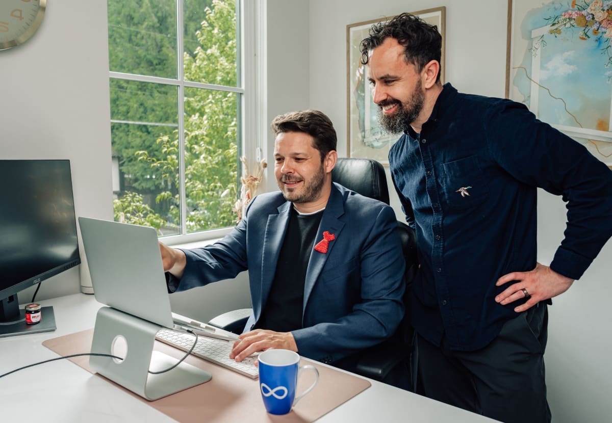 A freelance web designer helping a businessman build a better website